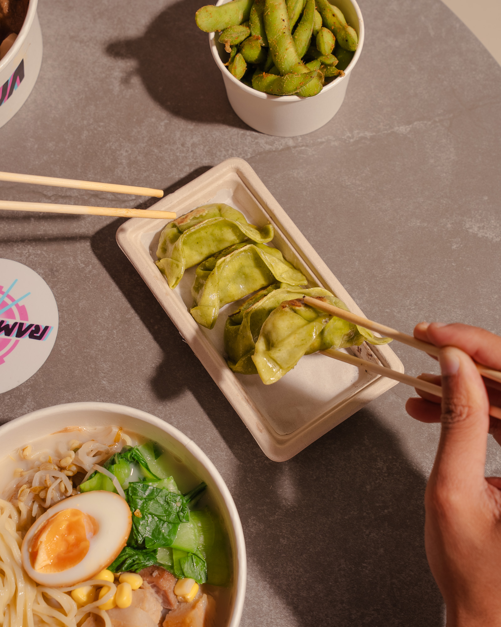 Green gyoza, edamame and a ramen bowl from above